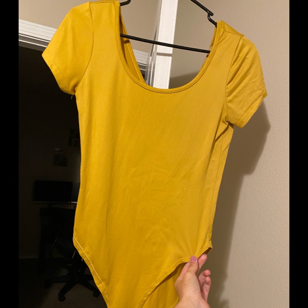 yellow body suit
